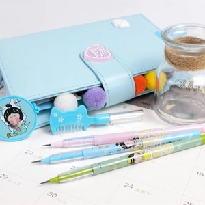 Close-up of light blue stationery pouch with pom-poms and matching colorful gel pens