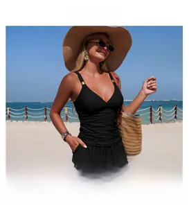 Detailed view of black one-piece tankini with V-neckline and gold metal hardware