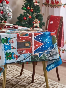 Detail of Christmas tablecloth with cartoon festive buildings and holiday decor scene
