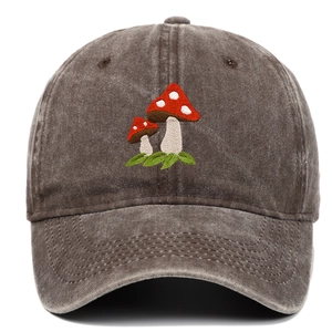 Close-up of mushroom embroidery on a vintage washed cotton baseball cap in dark brown