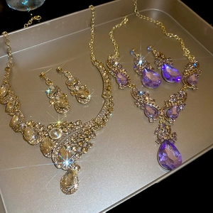 Detailed overhead view of crystal teardrop pendant necklaces and matching earrings sets