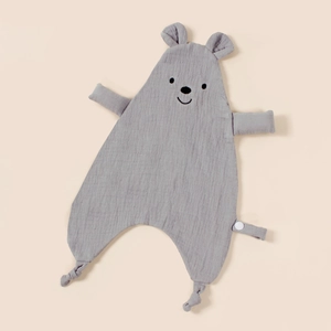Detail of gray muslin baby comforter with bear face embroidery and knotted corners