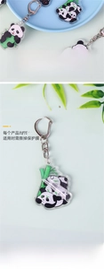 Close-up of cute acrylic panda keychain showing double-sided print and protective film