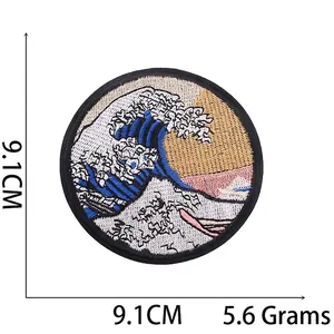 Macro detail of Great Wave embroidery patch showing 9.1cm diameter and fine stitching