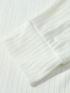 Macro detail of white and light blue vertical stripes on the ribbed polo shirt cuffs