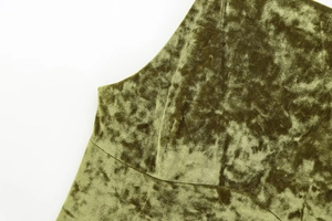 Detailed view of moss green crushed velvet fabric texture and professional shoulder seam