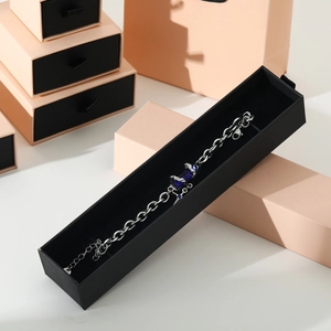 Detail of silver bracelet with blue gemstone inside a premium black drawer gift box
