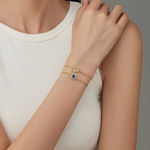 Classic stainless steel bracelets with yellow and blue zircon stones on a model's wrist