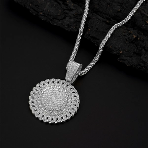 Close-up of hip hop pendant necklace with pavé zircons on textured wood background