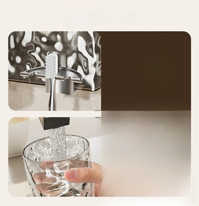 Close-up of stainless steel toothbrush holder with textured glass rinsing cup