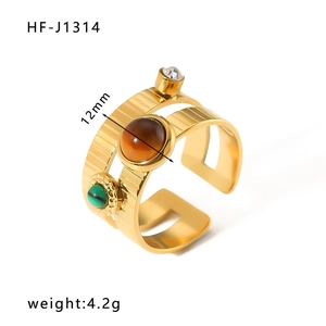 Détail d'une bague multicouche dorée avec pierre brune de 12 mm et incrustation verte