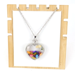 Polished heart-shaped pendant necklace filled with colorful natural stone chips