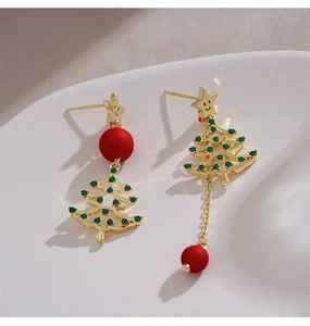 Detail of asymmetric Christmas tree earrings with green zircon and red beads