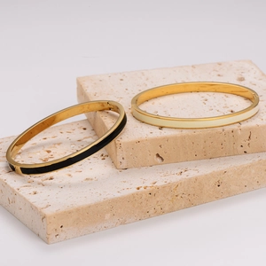 Minimalist gold plated stainless steel bangles with black and cream enamel inlay