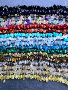 Macro shot of assorted irregular natural gemstone chips in diverse vibrant colors and textures
