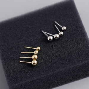Detail of 5mm ball stud earrings in gold and silver showing S925 sterling silver hallmarks
