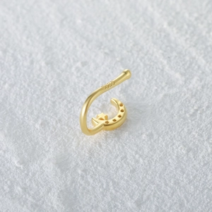 Close-up of S925 hallmark on a gold-plated moon and star non-piercing nose cuff