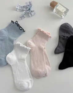 Detail of five pairs of pastel lace trim socks with vertical ribbed knit texture
