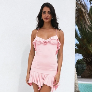 Detail of pink slip dress featuring a 3D rose decoration and elegant ruffle edges
