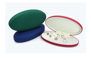 Oval PU leather jewelry box showing multiple colors and interior storage slots