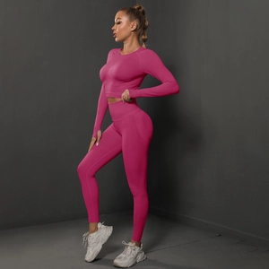 Macro detail of magenta high-waisted seamless peach lift yoga leggings with a crop top