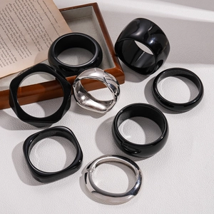 Chunky resin and silver metal geometric bangles set in minimalist modern style