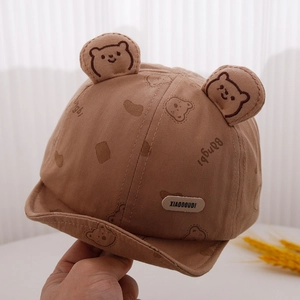 Detail showing bear ears and printed pattern on a soft cotton baby baseball cap