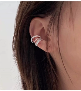 Detail view of silver layered ear cuff with white pearls and sparkling cubic zirconia stones