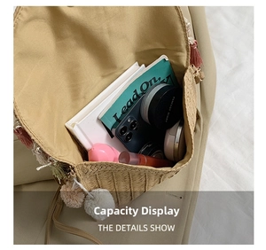 Detail view of woven straw tote interior with smartphone and cosmetics storage