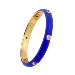 Close-up of royal blue enamel gold ring with embedded clear crystals in macro detail