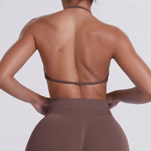 Seamless brown halter sports bra and high waist leggings set showing back muscle detail