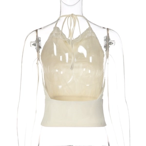 Detail of cream backless halter top featuring sheer lace patchwork and tie-back closure