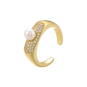 Detailed close-up of a gold adjustable ring with a pearl and sparkling crystal accents