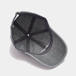 Detail view of washed grey cotton baseball cap showing inner seams and metal buckle
