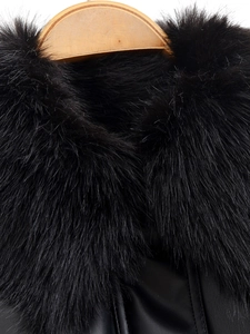 Close-up of the plush black faux fur collar and premium leather texture on a bomber jacket