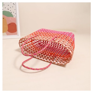 Close-up of pink and orange gradient woven basket showing hollow plastic mesh texture