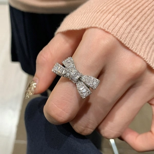 Elegant zircon bow open ring for women in silver finish shown on a finger