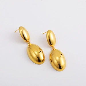 Detailed close-up of 18K gold double spherical drop earrings with a high-polished mirror finish
