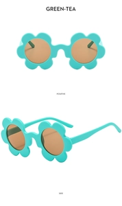 Detail view of flower-shaped children's sunglasses in green tea color with brown lenses