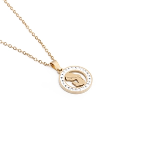 Macro detail of golden Mother's Day necklace with rhinestone heart and silhouette