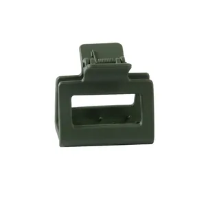 Detail shot of a dark green matte rectangular claw clip with a durable metal spring
