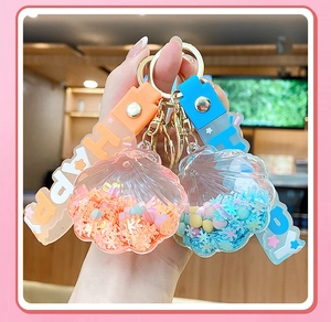 Close-up of blue and orange shell quicksand keychains with colorful silicone straps
