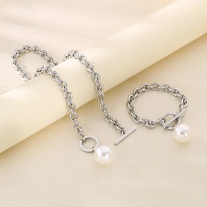 Detail of silver titanium steel jewelry set with pearl pendants and OT toggle clasps