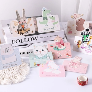 Flat lay detail of cute cartoon greeting cards with 'You're Sweet' and 'Good luck' text