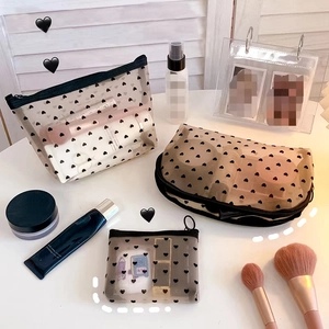 Three-piece set of black heart-patterned mesh cosmetic bags with zip closures