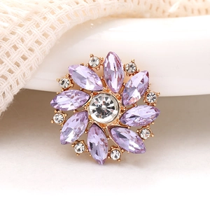 Exquisite purple crystal flower brooch with gold plating on a soft knitted fabric