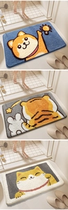 Detailed view of plush animal-shaped bathroom mats featuring Shiba Inu and Tiger designs