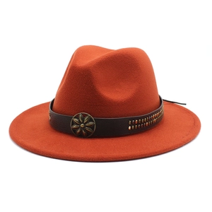 Detail of caramel orange wool fedora with leather band and bronze floral buckle