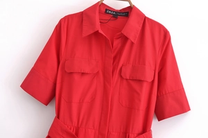 Detail of red short-sleeve poplin shirt dress with utility pockets and matching belt