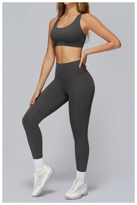 Detailed close-up of dark charcoal gray yoga leggings and U-neck sports bra set for women
